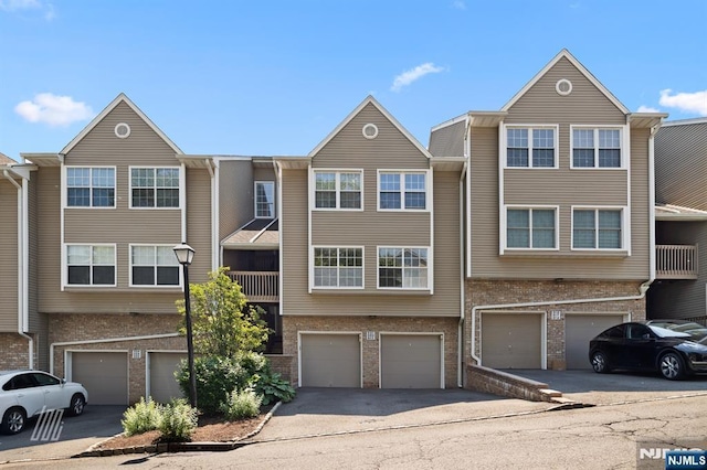 519 Windsor Dr Unit 204, Palisades Park, NJ 07650 - multi unit property with brick siding, a garage, and driveway