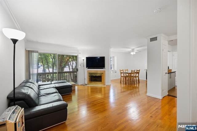 519 Windsor Dr Unit 204, Palisades Park, NJ 07650 - living area featuring a ceiling fan, light wood-style flooring, a fireplace, crown molding, and baseboards
