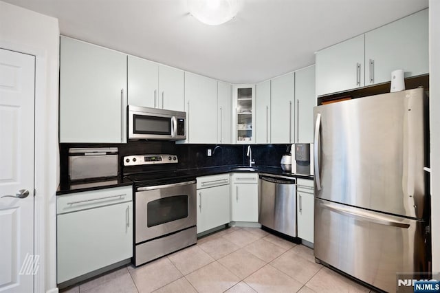 519 Windsor Dr Unit 204, Palisades Park, NJ 07650 - kitchen with stainless steel appliances, dark countertops, a sink, and light tile patterned flooring