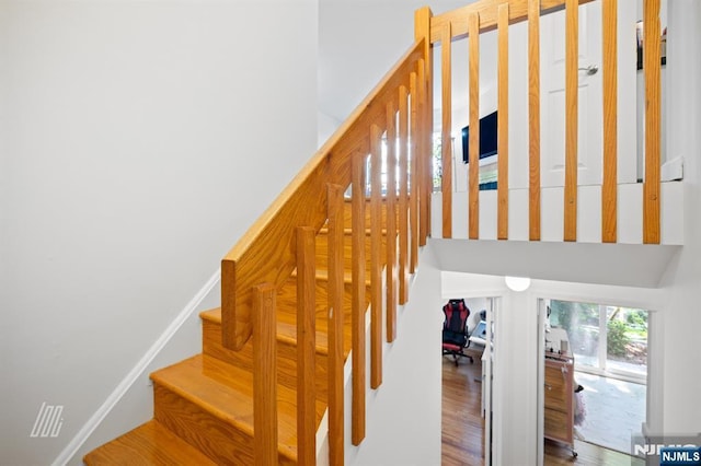 519 Windsor Dr Unit 204, Palisades Park, NJ 07650 - staircase featuring a towering ceiling and wood finished floors
