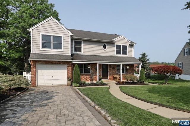 14 Swan Ct, East Rutherford, NJ 07073 - view of front of home featuring a porch, an attached garage, a front yard, decorative driveway, and brick siding