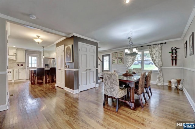 14 Swan Ct, East Rutherford, NJ 07073 - dining room with a chandelier, healthy amount of natural light, wood finished floors, crown molding, and stairway