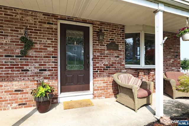 14 Swan Ct, East Rutherford, NJ 07073 - property entrance with covered porch and brick siding