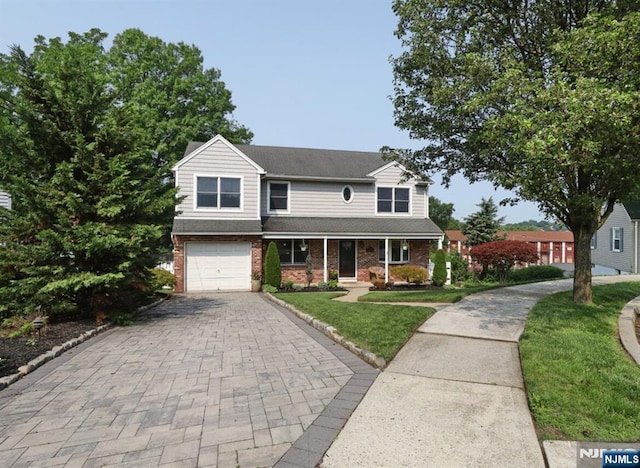 14 Swan Ct, East Rutherford, NJ 07073 - traditional home with decorative driveway, an attached garage, a front yard, brick siding, and a porch
