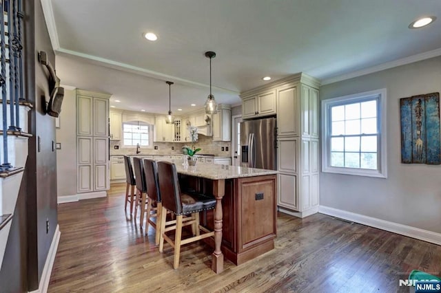 14 Swan Ct, East Rutherford, NJ 07073 - kitchen featuring stainless steel fridge, dark wood finished floors, light stone countertops, a center island, and a kitchen bar