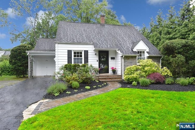 408 Eton Ct, Ridgewood, NJ 07450 - cape cod home with a chimney, a front lawn, a garage, asphalt driveway, and roof with shingles