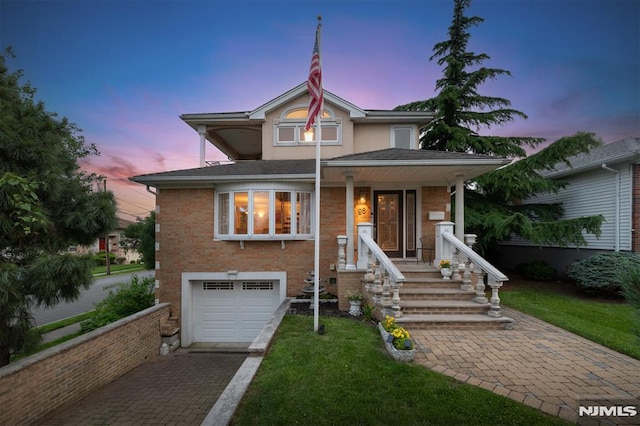 28 Elizabeth Ct, Secaucus, NJ 07094 - view of front of property featuring a garage, driveway, a front lawn, and brick siding
