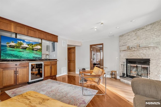 28 Elizabeth Ct, Secaucus, NJ 07094 - living area featuring beverage cooler, wet bar, wood finished floors, a fireplace, and baseboards