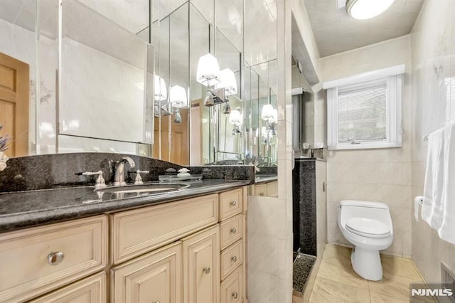 28 Elizabeth Ct, Secaucus, NJ 07094 - bathroom with tile walls, vanity, toilet, and tile patterned flooring