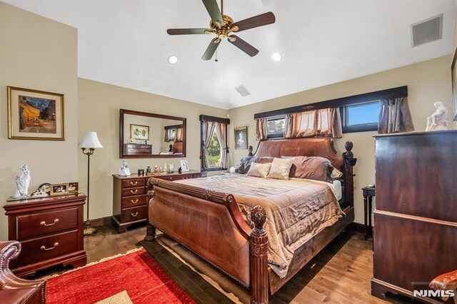 28 Elizabeth Ct, Secaucus, NJ 07094 - bedroom with multiple windows, wood finished floors, lofted ceiling, recessed lighting, and baseboards