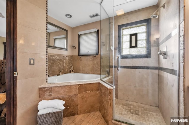 28 Elizabeth Ct, Secaucus, NJ 07094 - bathroom with a shower stall, a bath, and tile walls