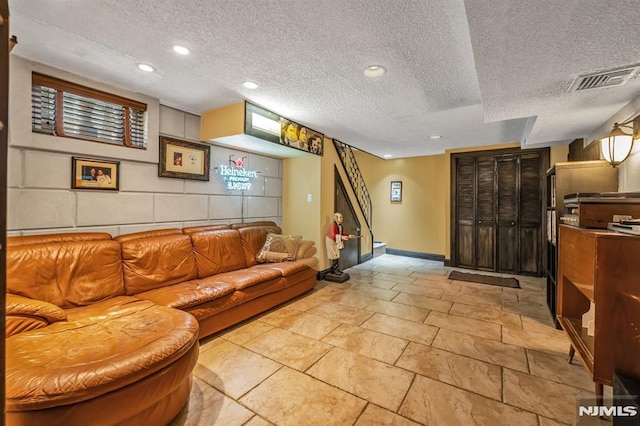 28 Elizabeth Ct, Secaucus, NJ 07094 - living area with baseboards, a textured ceiling, stone tile floors, a baseboard radiator, and recessed lighting