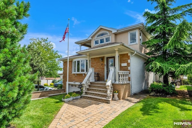 28 Elizabeth Ct, Secaucus, NJ 07094 - view of front of house with a front lawn, brick siding, and stucco siding