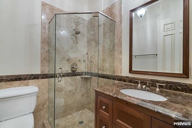 11 Margo Way, Alpine, NJ 07620 - bathroom with tile walls, vanity, a stall shower, and a wainscoted wall