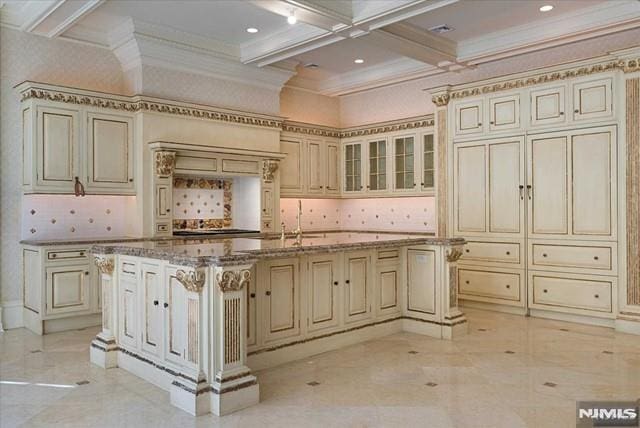 11 Margo Way, Alpine, NJ 07620 - kitchen featuring cream cabinets, crown molding, beamed ceiling, coffered ceiling, and decorative backsplash