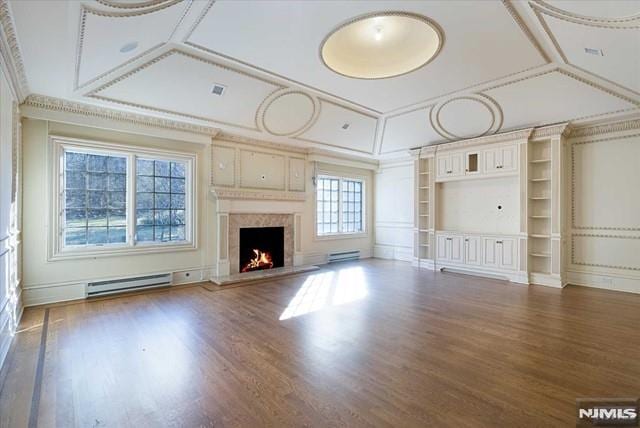 11 Margo Way, Alpine, NJ 07620 - unfurnished living room with baseboard heating, wood finished floors, crown molding, a premium fireplace, and built in shelves