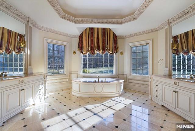 11 Margo Way, Alpine, NJ 07620 - bathroom featuring a raised ceiling, a bath, wainscoting, and vanity