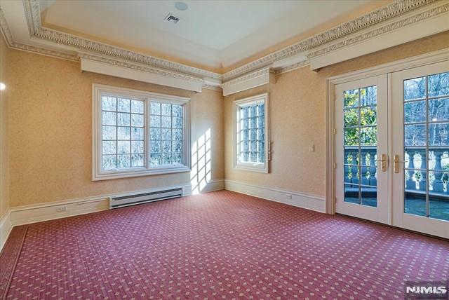 11 Margo Way, Alpine, NJ 07620 - carpeted spare room featuring a baseboard radiator, plenty of natural light, crown molding, and french doors