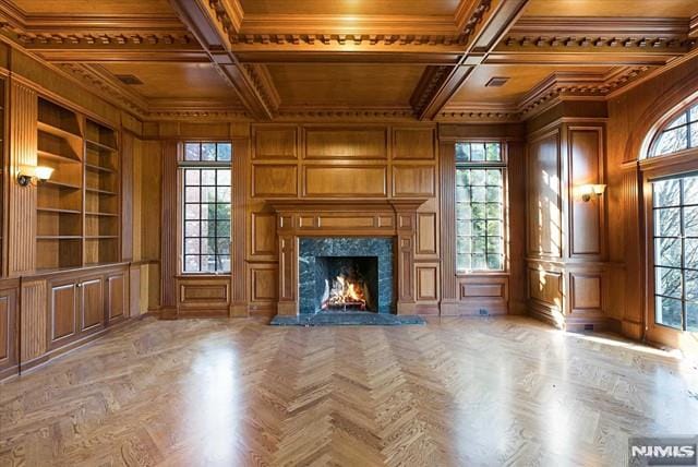 11 Margo Way, Alpine, NJ 07620 - unfurnished living room featuring a wooden ceiling with exposed beams, crown molding, built in features, a fireplace, and coffered ceiling