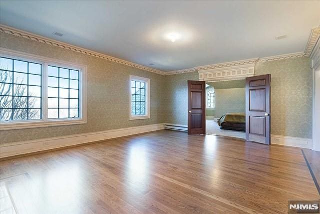 11 Margo Way, Alpine, NJ 07620 - empty room featuring baseboard heating, wood finished floors, ornamental molding, and wallpapered walls