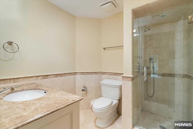11 Margo Way, Alpine, NJ 07620 - bathroom featuring vanity, a stall shower, a wainscoted wall, tile walls, and tile patterned floors