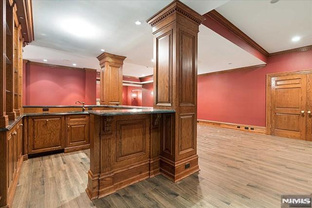 11 Margo Way, Alpine, NJ 07620 - bar with decorative columns, crown molding, wood finished floors, and recessed lighting