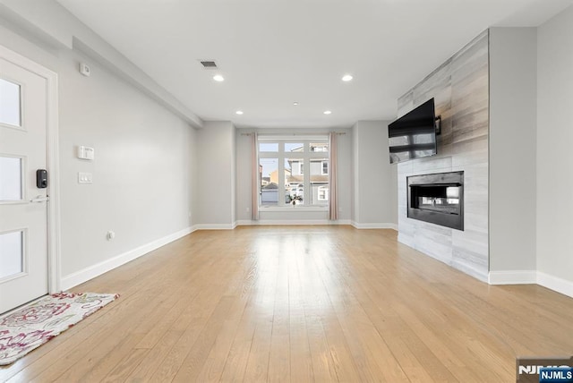 805 Fairview Ln, Fort Lee, NJ 07024 - unfurnished living room featuring light wood finished floors, a fireplace, baseboards, and recessed lighting