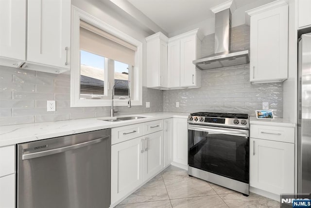 805 Fairview Ln, Fort Lee, NJ 07024 - kitchen featuring stainless steel appliances, wall chimney range hood, a sink, light marble finish floors, and white cabinetry