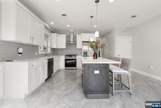 805 Fairview Ln, Fort Lee, NJ 07024 - kitchen with appliances with stainless steel finishes, light marble finish flooring, wall chimney exhaust hood, a center island, and recessed lighting