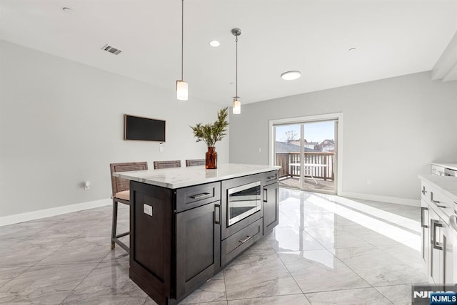 805 Fairview Ln, Fort Lee, NJ 07024 - kitchen with light marble finish flooring, stainless steel microwave, light countertops, and baseboards