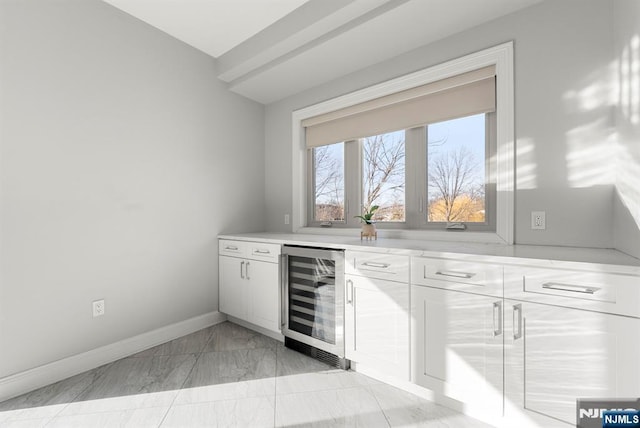 805 Fairview Ln, Fort Lee, NJ 07024 - indoor dry bar featuring wine cooler, light marble finish flooring, and baseboards