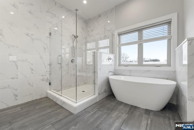 805 Fairview Ln, Fort Lee, NJ 07024 - full bathroom with a soaking tub, a marble finish shower, tile walls, and wood finished floors