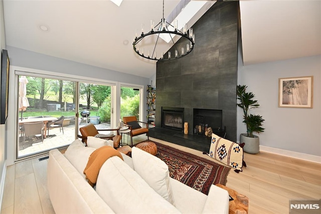 403 Barringer Ct, West Orange, NJ 07052 - living room featuring a chandelier, a large fireplace, baseboards, wood finished floors, and high vaulted ceiling