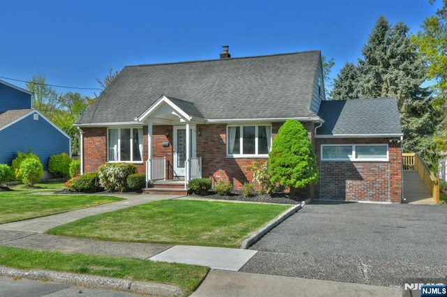 11-06 Marshall Rd, Fair Lawn, NJ 07410 - cape cod house with brick siding, a front yard, and a shingled roof