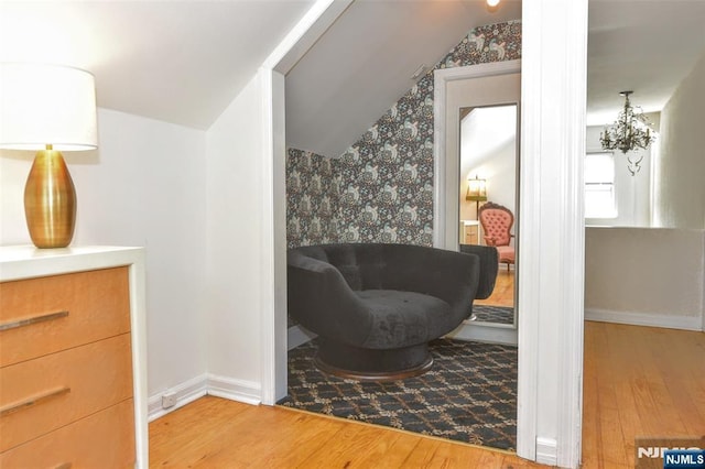 11-06 Marshall Rd, Fair Lawn, NJ 07410 - living area featuring lofted ceiling, wood finished floors, wallpapered walls, and baseboards