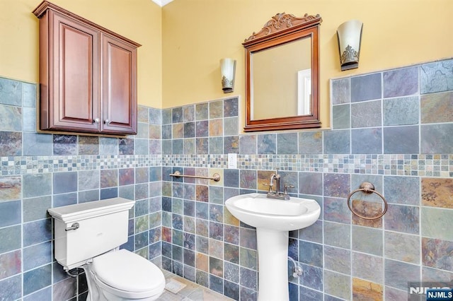 72 Francisco Ave, Little Falls, NJ 07424 - half bath featuring tile walls, toilet, and a wainscoted wall