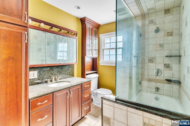 72 Francisco Ave, Little Falls, NJ 07424 - bathroom featuring toilet, tiled shower / bath, vanity, tile patterned floors, and decorative backsplash