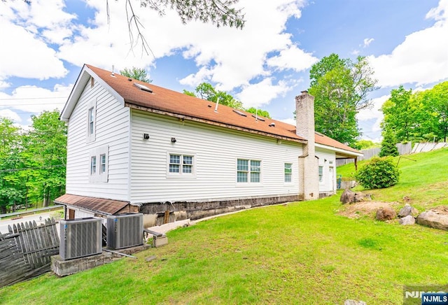 72 Francisco Ave, Little Falls, NJ 07424 - rear view of house featuring central AC and a chimney