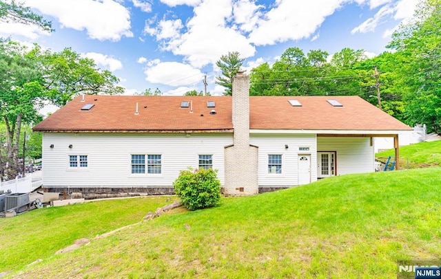 72 Francisco Ave, Little Falls, NJ 07424 - rear view of house with central AC unit, a chimney, and a lawn