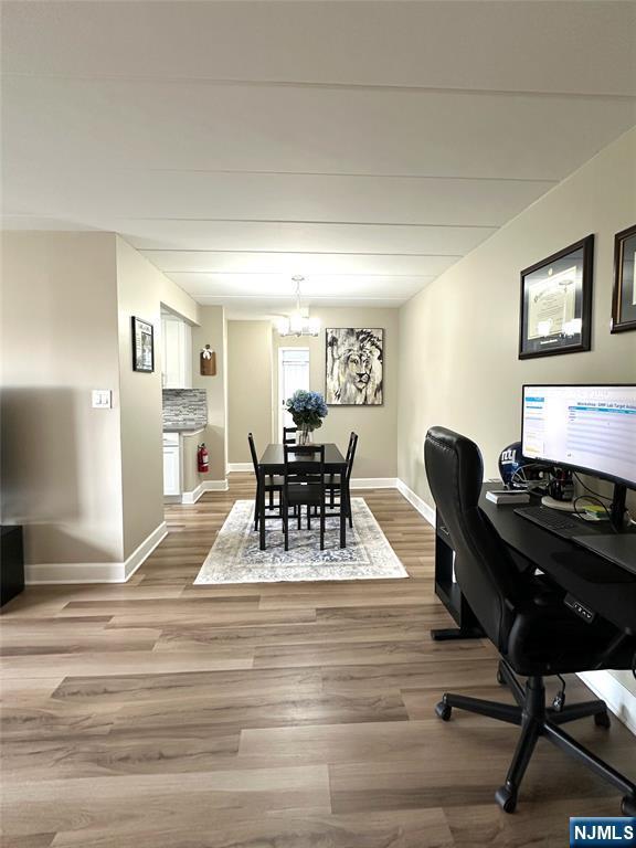 25 Jefferson St Unit 6E, Hackensack, NJ 07601 - dining room with wood finished floors, a chandelier, baseboards, and a desk