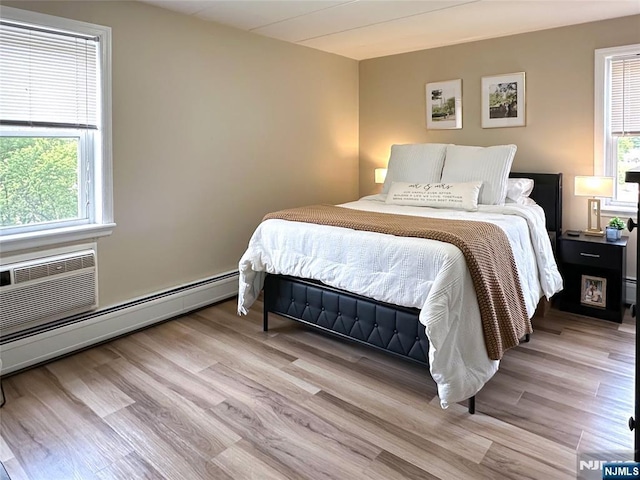 25 Jefferson St Unit 6E, Hackensack, NJ 07601 - bedroom featuring wood finished floors, a baseboard radiator, and a wall mounted air conditioner