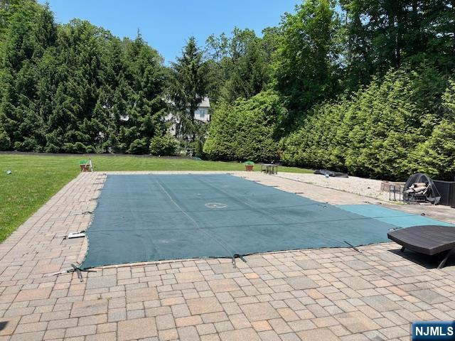 889 Circle Ave, Franklin Lakes, NJ 07417 - view of pool with a patio area, a lawn, and a covered pool