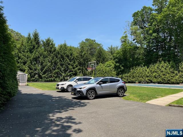 889 Circle Ave, Franklin Lakes, NJ 07417 - uncovered parking lot with a forest view