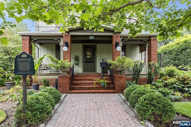 33 Ramapo Ave, Pompton Lakes, NJ 07442 - view of front of house featuring covered porch and brick siding