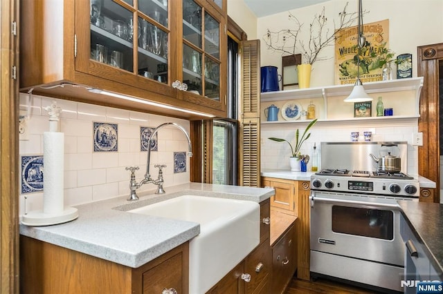 33 Ramapo Ave, Pompton Lakes, NJ 07442 - kitchen featuring high end range, decorative backsplash, a sink, and glass insert cabinets