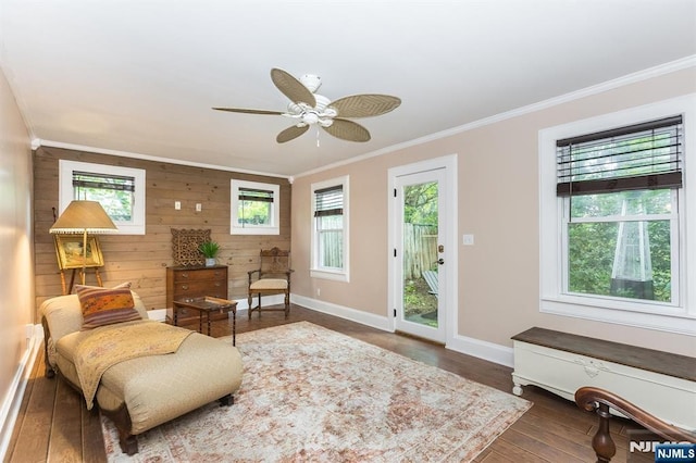 33 Ramapo Ave, Pompton Lakes, NJ 07442 - living area featuring ornamental molding, healthy amount of natural light, wood walls, baseboards, and ceiling fan