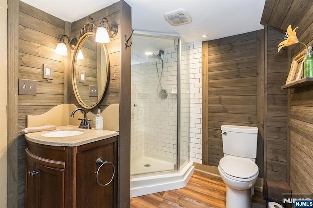 33 Ramapo Ave, Pompton Lakes, NJ 07442 - full bath with vanity, a stall shower, toilet, wood walls, and wood finished floors