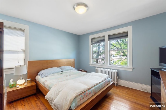 42 Oakwood Ave, Bogota, NJ 07603 - bedroom featuring radiator heating unit, wood finished floors, and baseboards