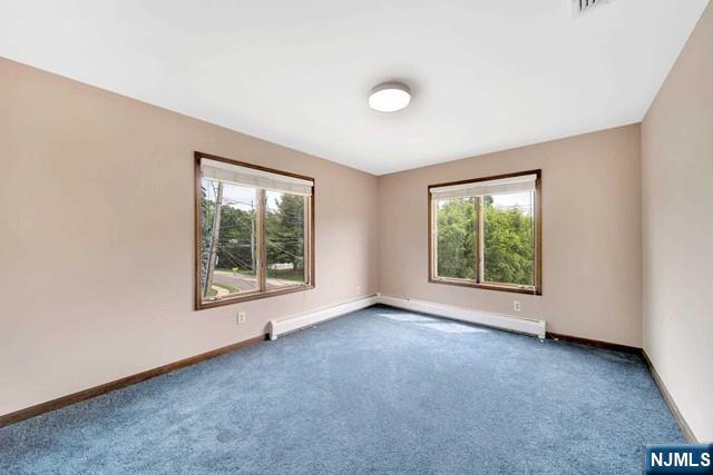 23 Bohnert Pl, Waldwick, NJ 07463 - carpeted empty room with a baseboard heating unit and baseboards