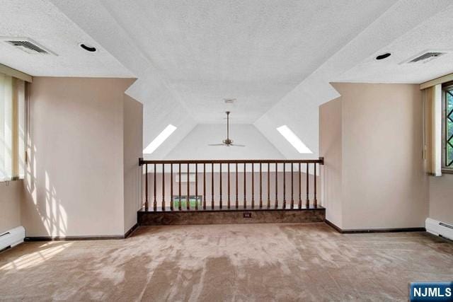 23 Bohnert Pl, Waldwick, NJ 07463 - empty room featuring carpet flooring, a textured ceiling, baseboards, ceiling fan, and baseboard heating